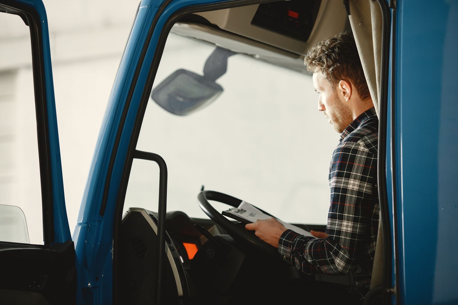 Driver completing fuel and mileage paperwork