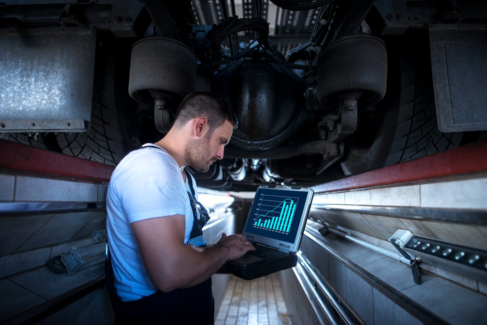 Technician setting up fleet software on a laptop